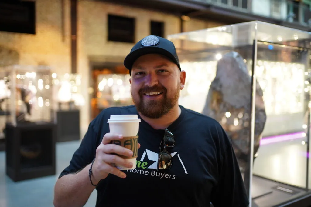 Gavin Timms, coffee in hand, in an urban setting